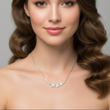 Woman wearing a necklace with a gray background
