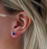 Close up of the prong setting and butterfly clasp on silver star sapphire studs